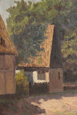 Maleri af ''house by the lake'' i gylden ramme.